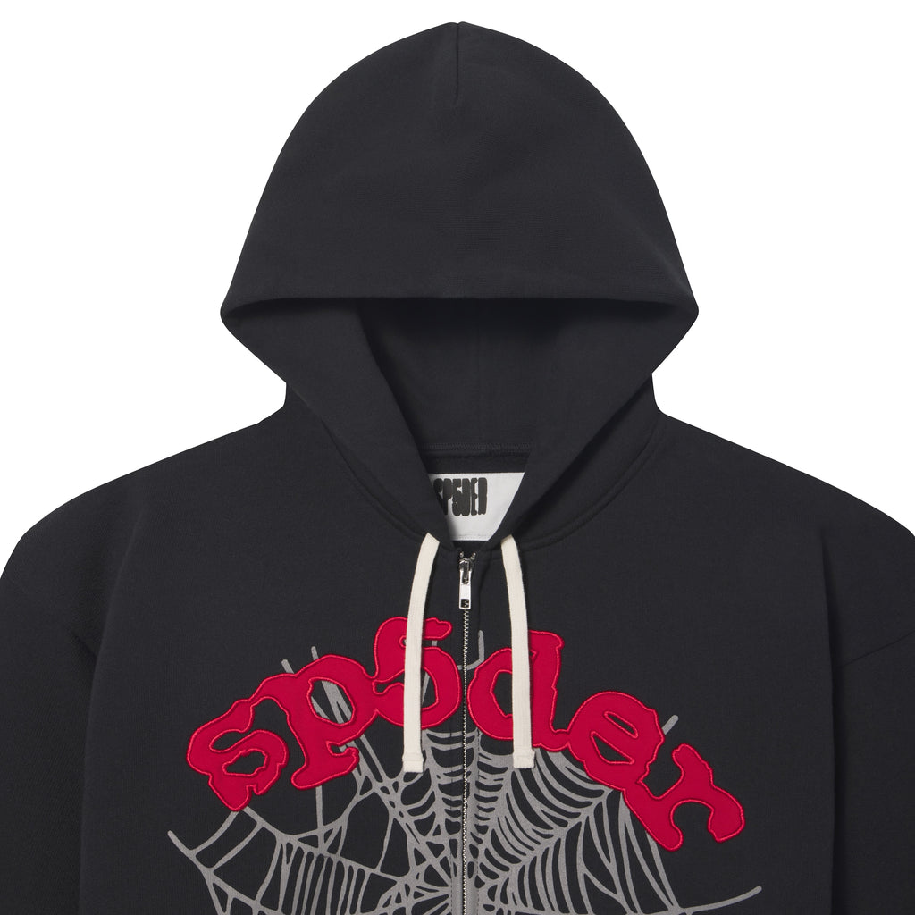 Black 13oz cotton fleece zip hoodie featuring a red appliqué logo and grey web graphic print with contrast white drawstrings.