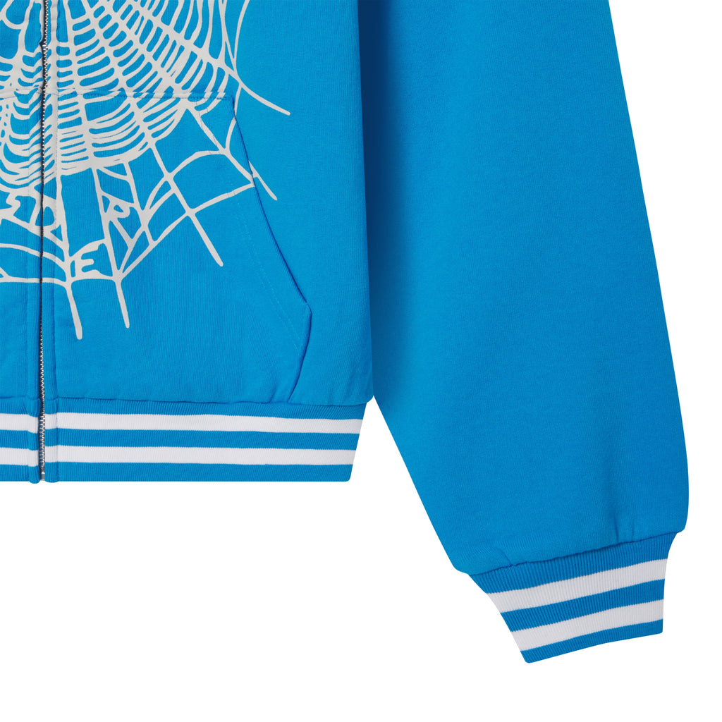 Bright blue 13oz cotton fleece zip hoodie featuring a white web graphic print and striped ribbed cuffs and hem.