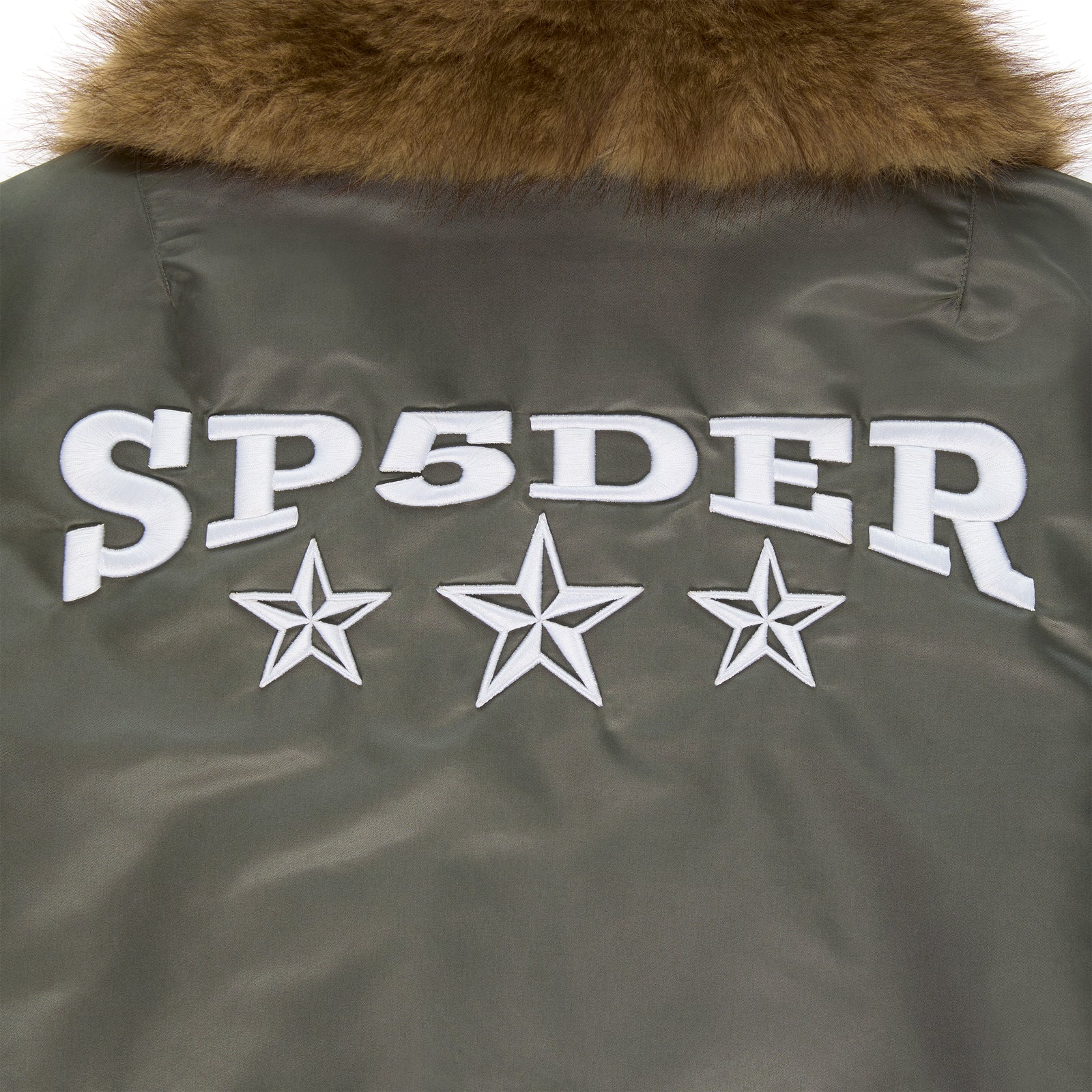 Olive nylon flight jacket with brown faux fur collar and white embroidered SP5DER graphic with stars.