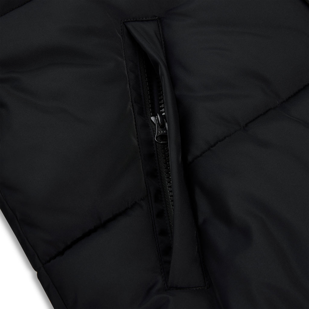Black poly-fill puffer jacket with a visible side pocket zipper.