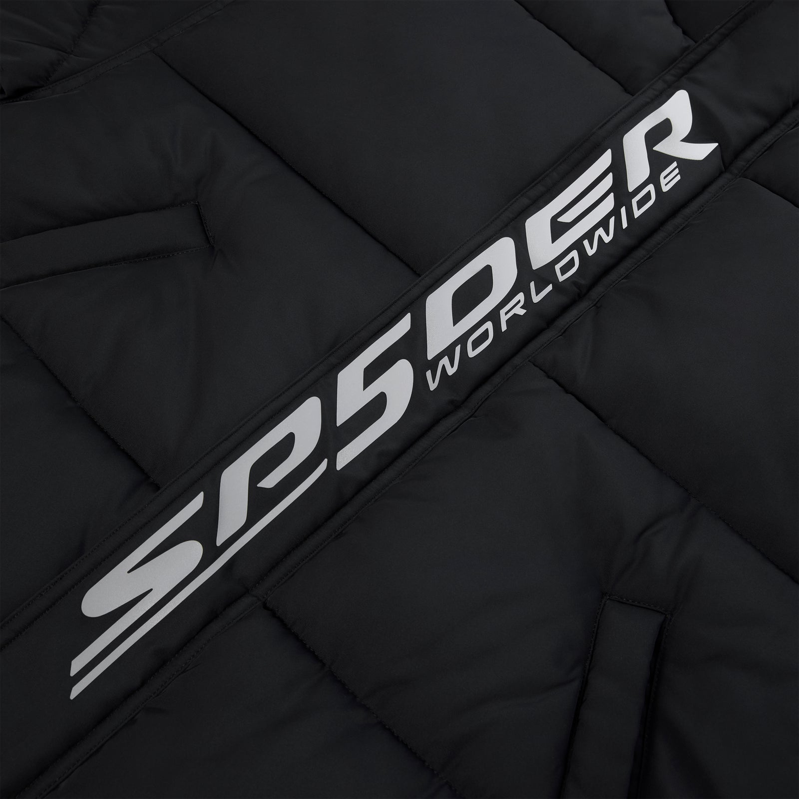 Black poly-fill puffer jacket with reflective "SP5DER WORLDWIDE" graphic along the front placket.