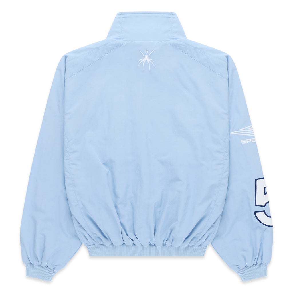 Light blue nylon track jacket, back view, with white spider logo on upper back and white sleeve graphic.