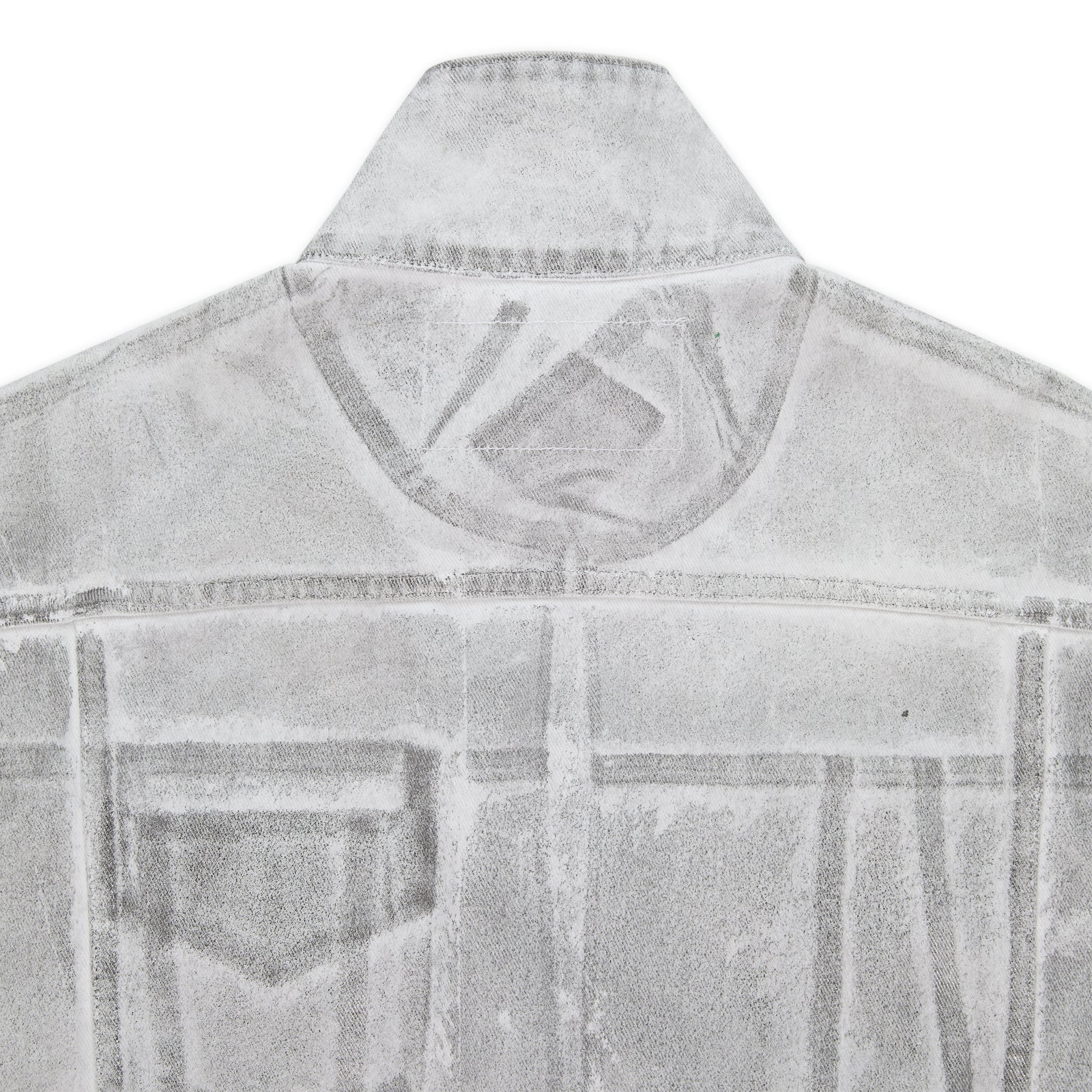 Back of a platinum trucker jacket with spray-effect denim, contrast seams, and structured fit.