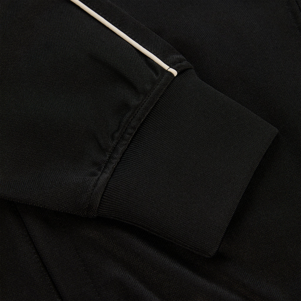 Black polyester Atlanta Track Jacket sleeve with white piping and ribbed cuff.