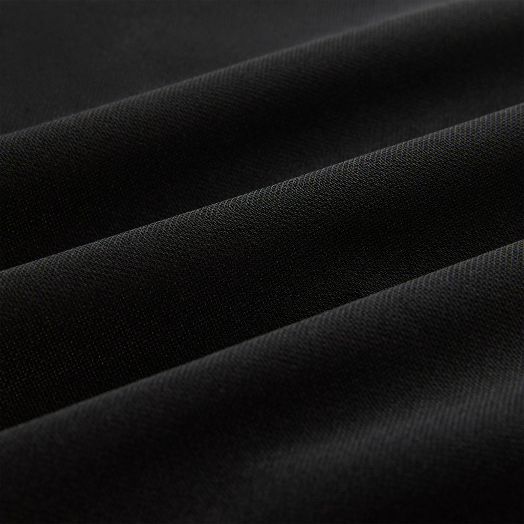 Close-up of black athletic polyester fabric with subtle texture and soft folds.
