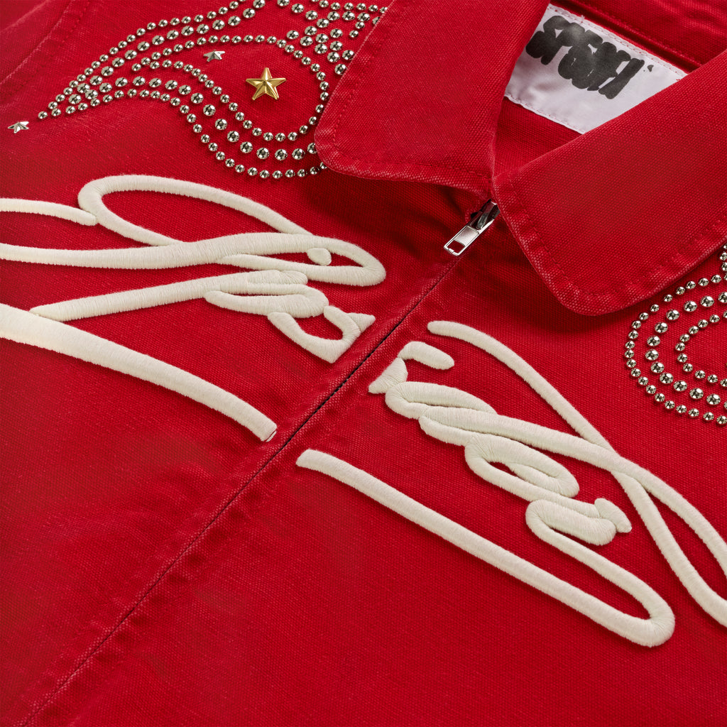 Red cotton canvas bomber jacket with white embroidered script, silver studs, and a gold star.