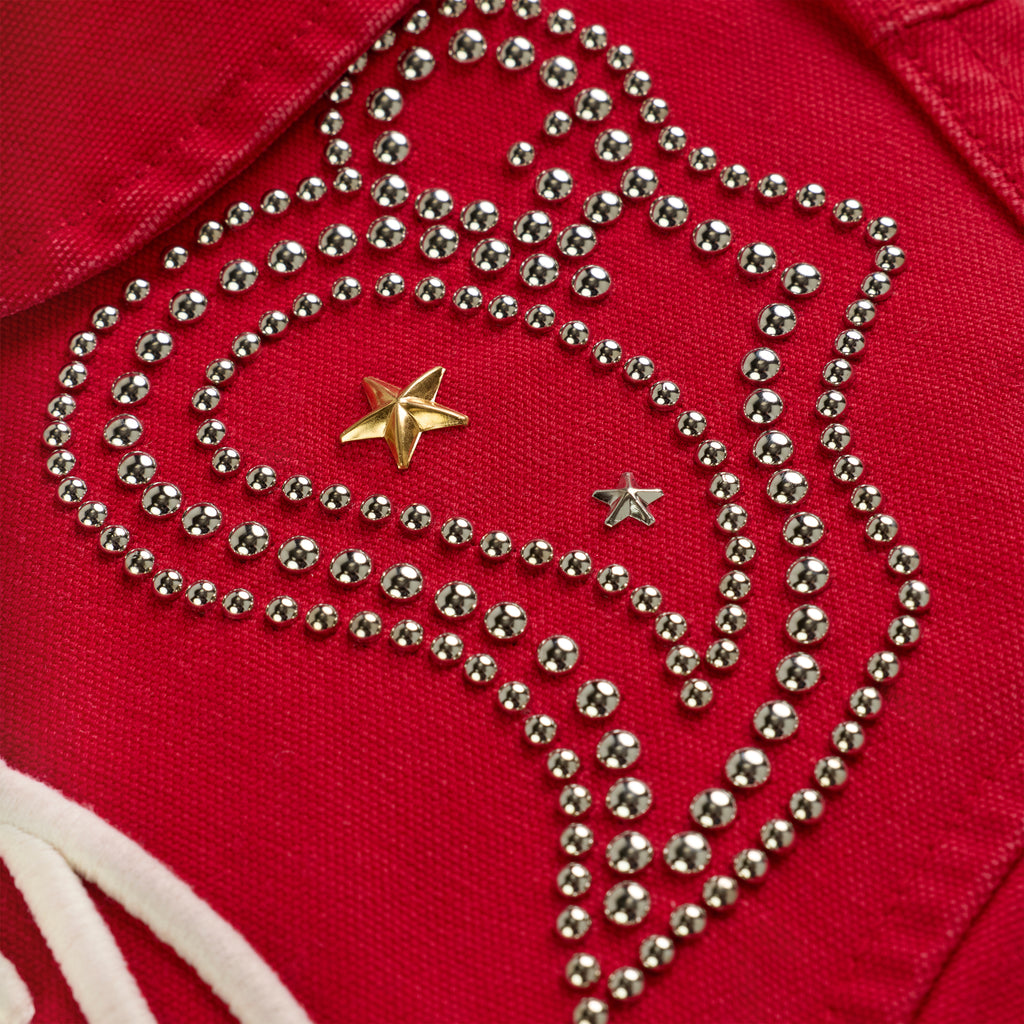 Red cotton canvas jacket with silver studs forming a swirling pattern, featuring gold and silver star studs.
