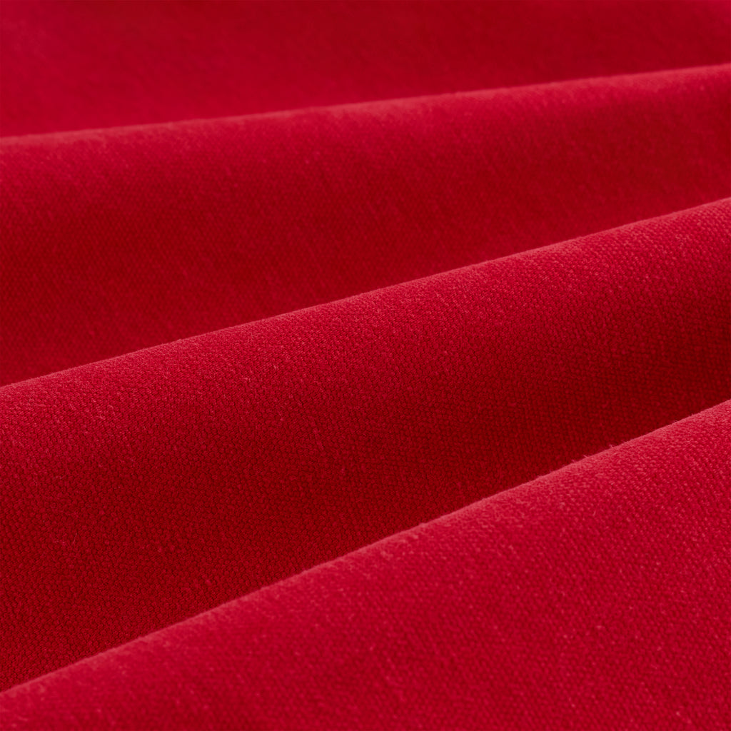 Close-up of vibrant red cotton canvas fabric, showing textured folds.