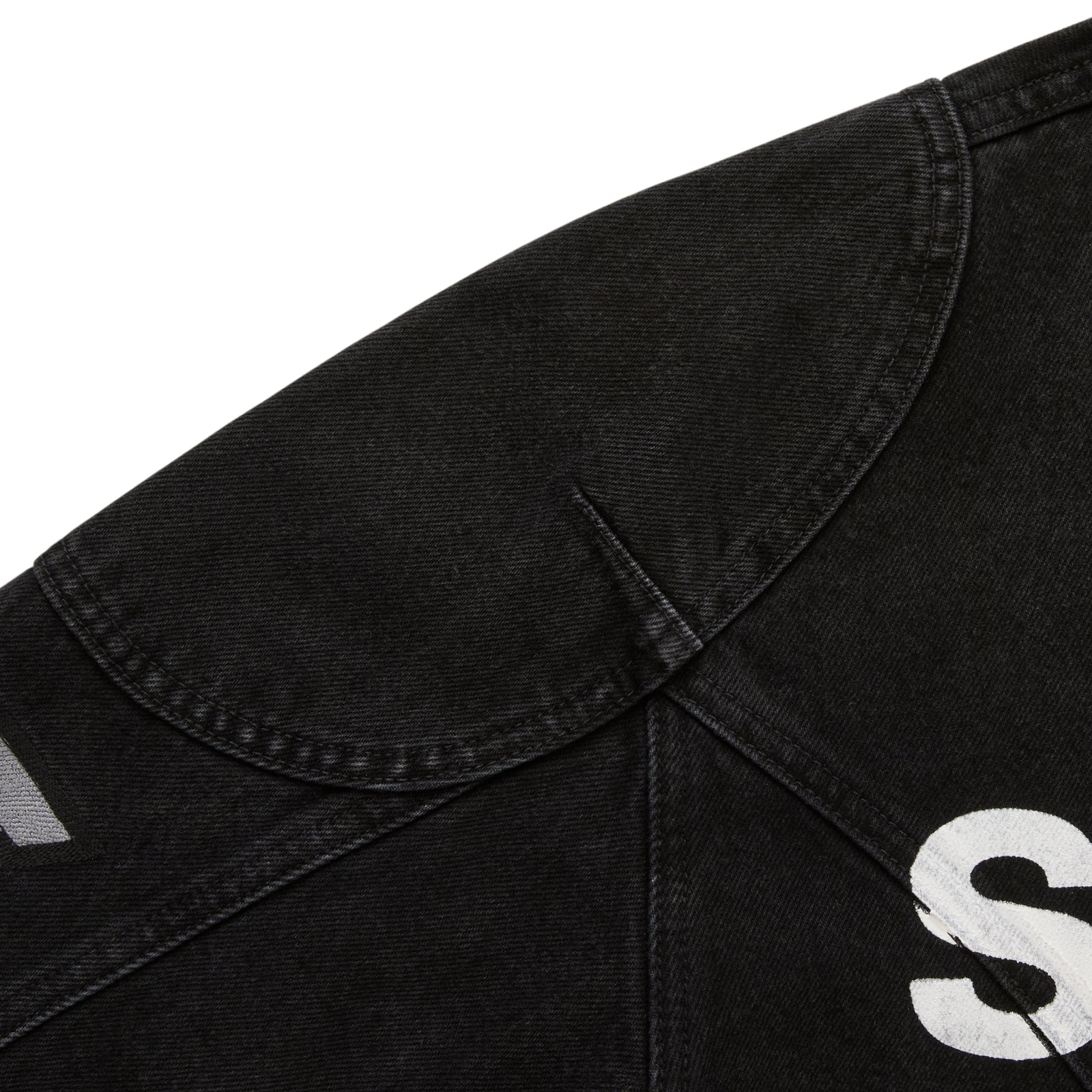 Faded black denim jacket with shoulder panel, SP5DER print, and star print.