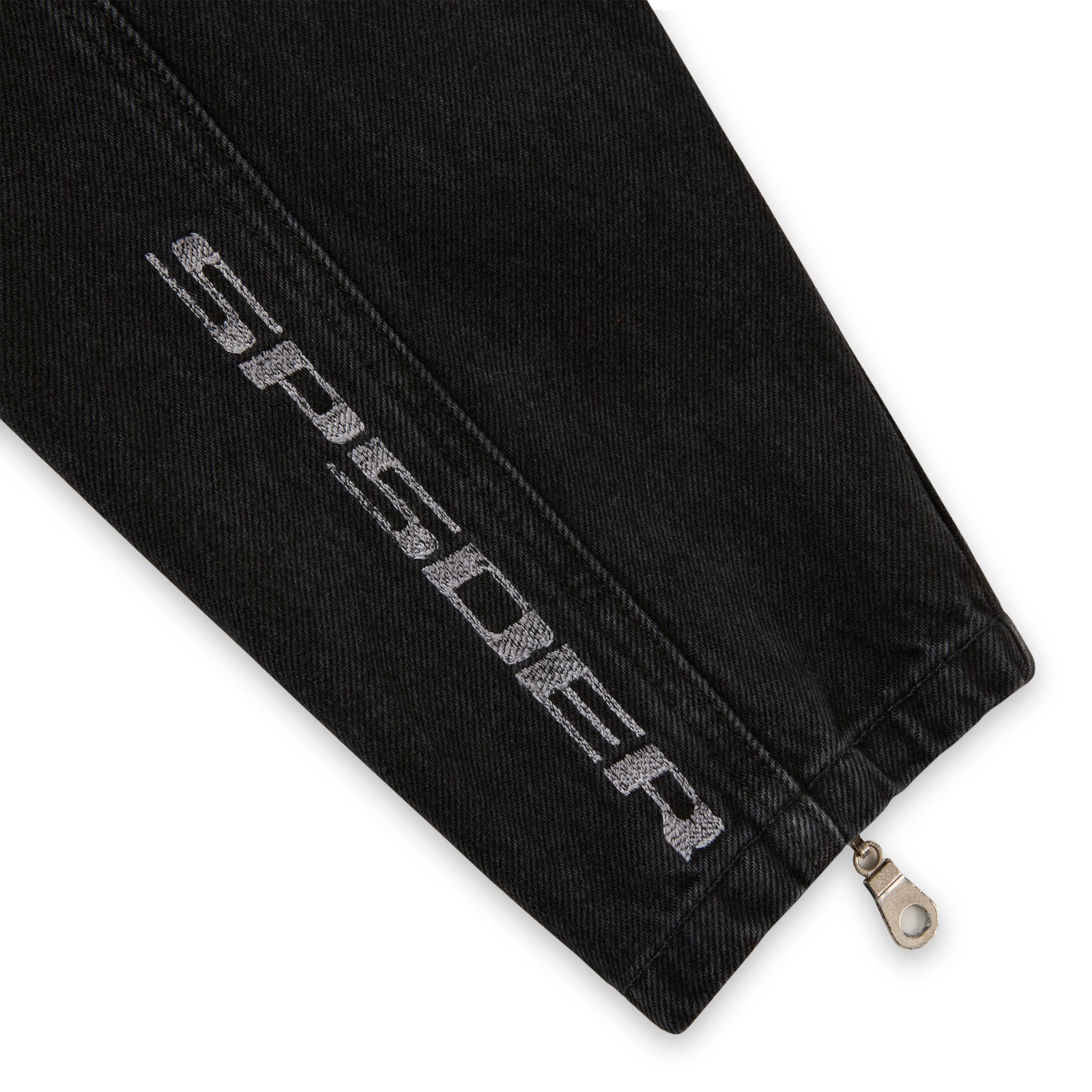 Black faded wash denim jacket sleeve with "SP5DER" embroidery and zip cuff.