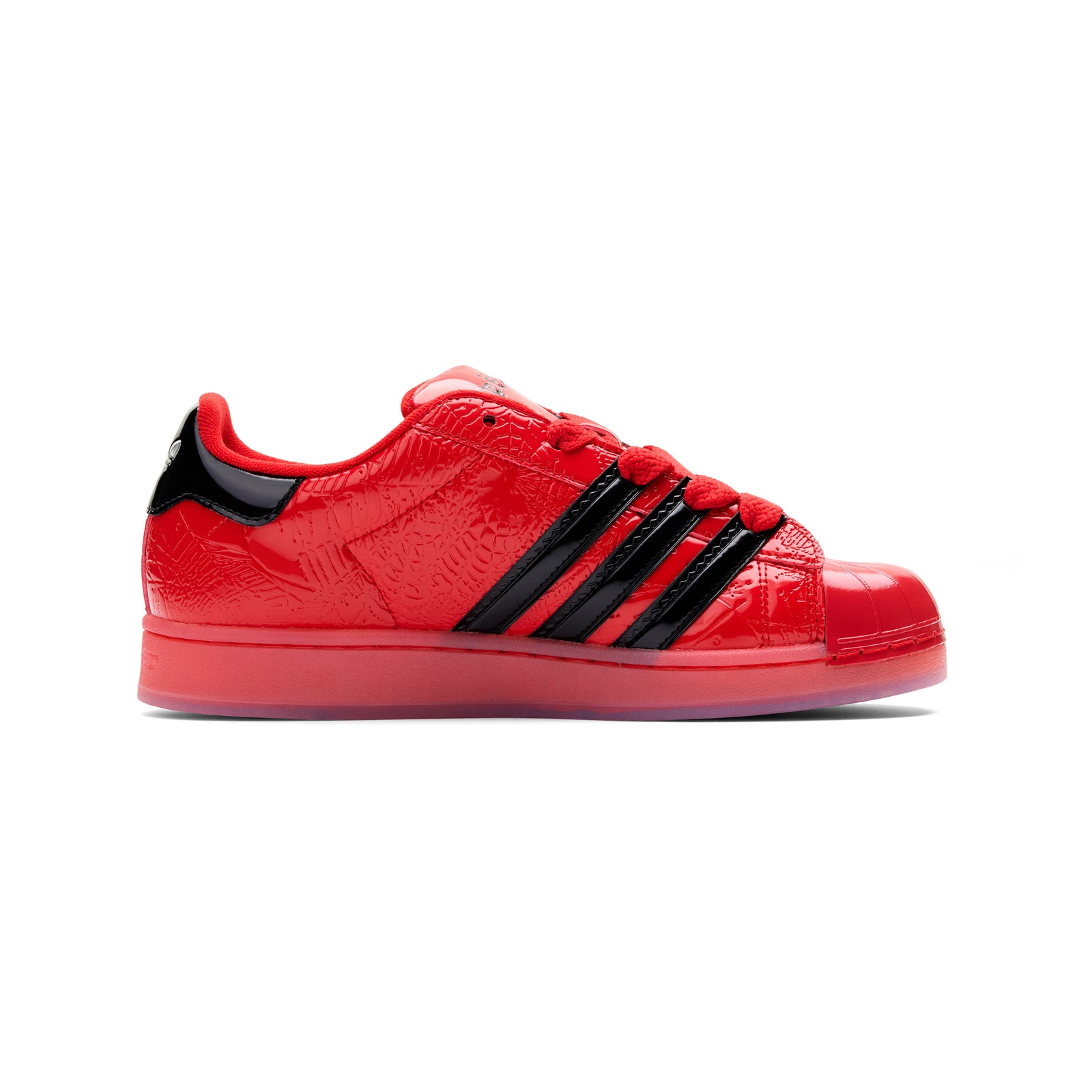 SP5DER x ADIDAS SUPERSTAR in glossy red patent leather with black stripes and spider charm.