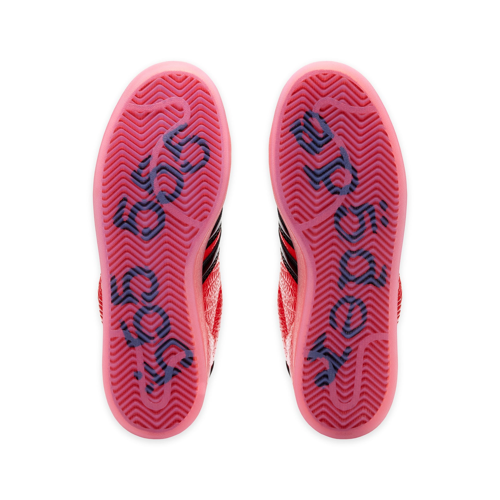 SP5DER x ADIDAS SUPERSTAR sneakers with translucent red outsoles featuring dark graphic detailing.