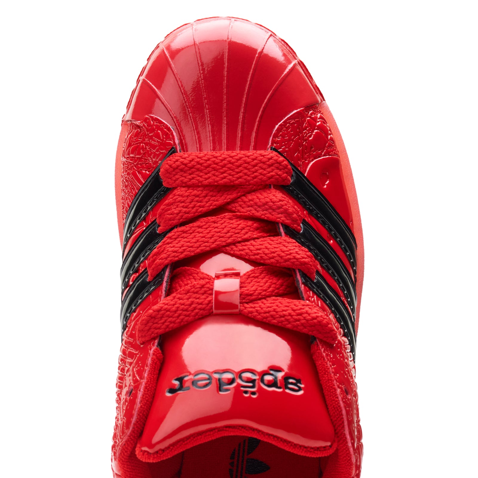 SP5DER x ADIDAS SUPERSTAR red glossy patent leather sneaker with black stripes and laces.
