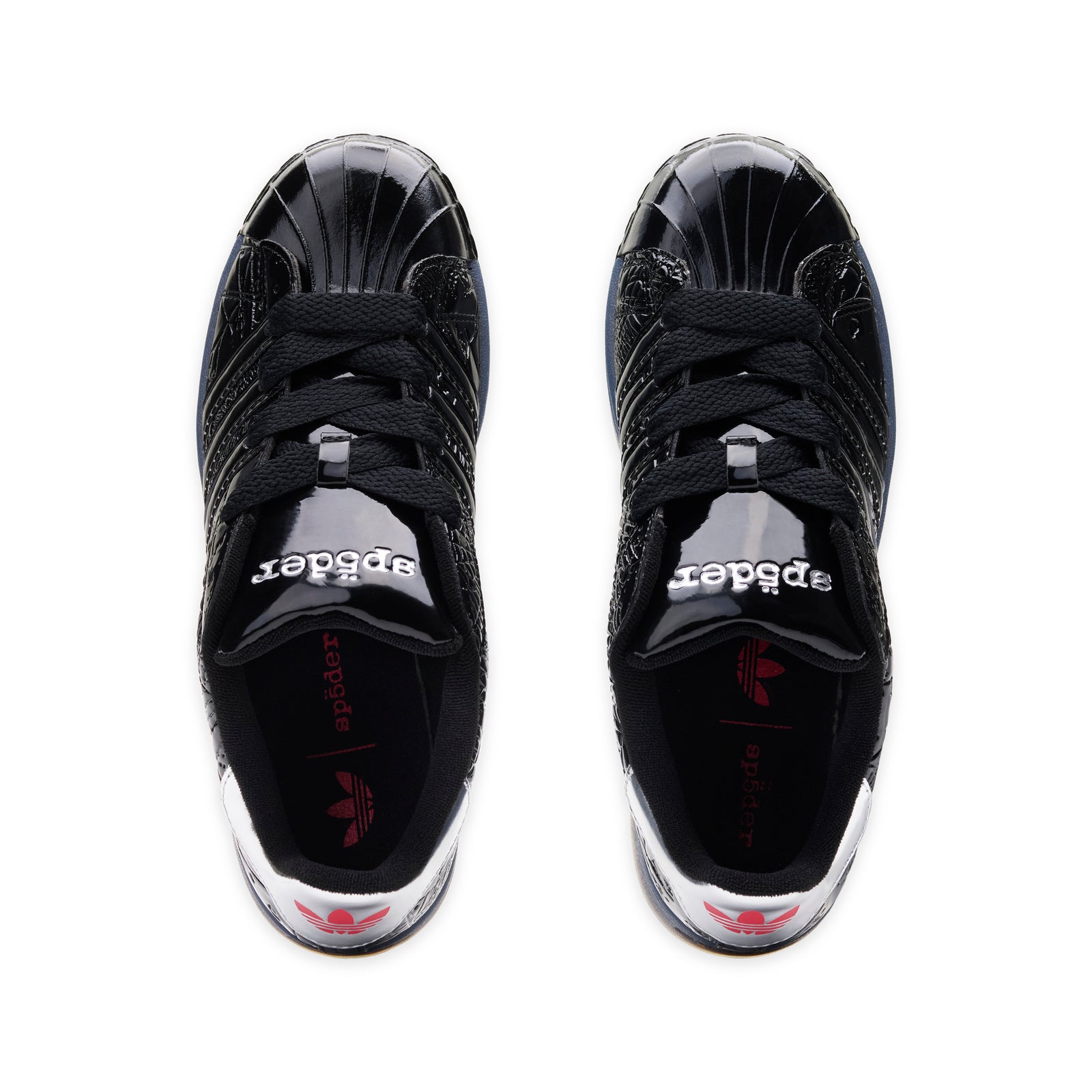 SP5DER x ADIDAS SUPERSTAR black glossy patent leather sneakers with spider charm and "555" detail.