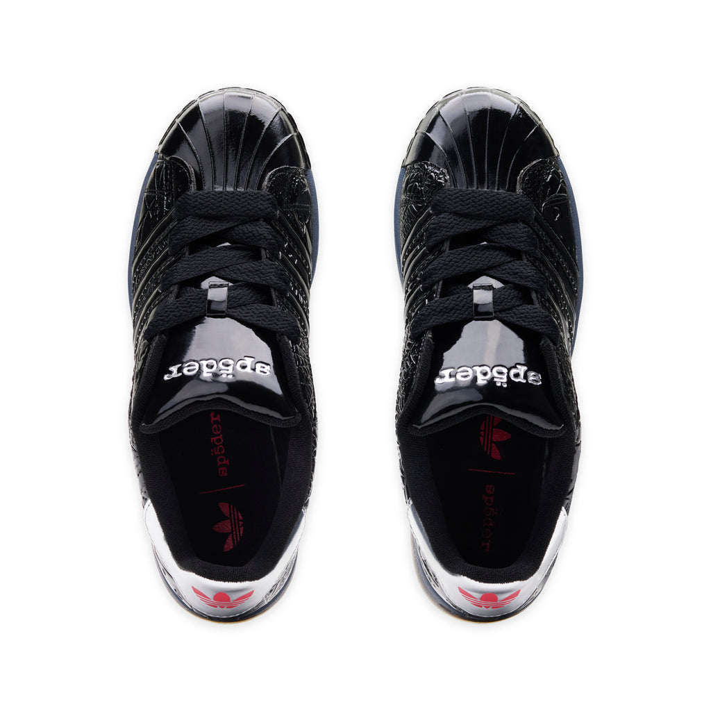 SP5DER x ADIDAS SUPERSTAR black glossy patent leather sneakers with spider charm and "555" detail.