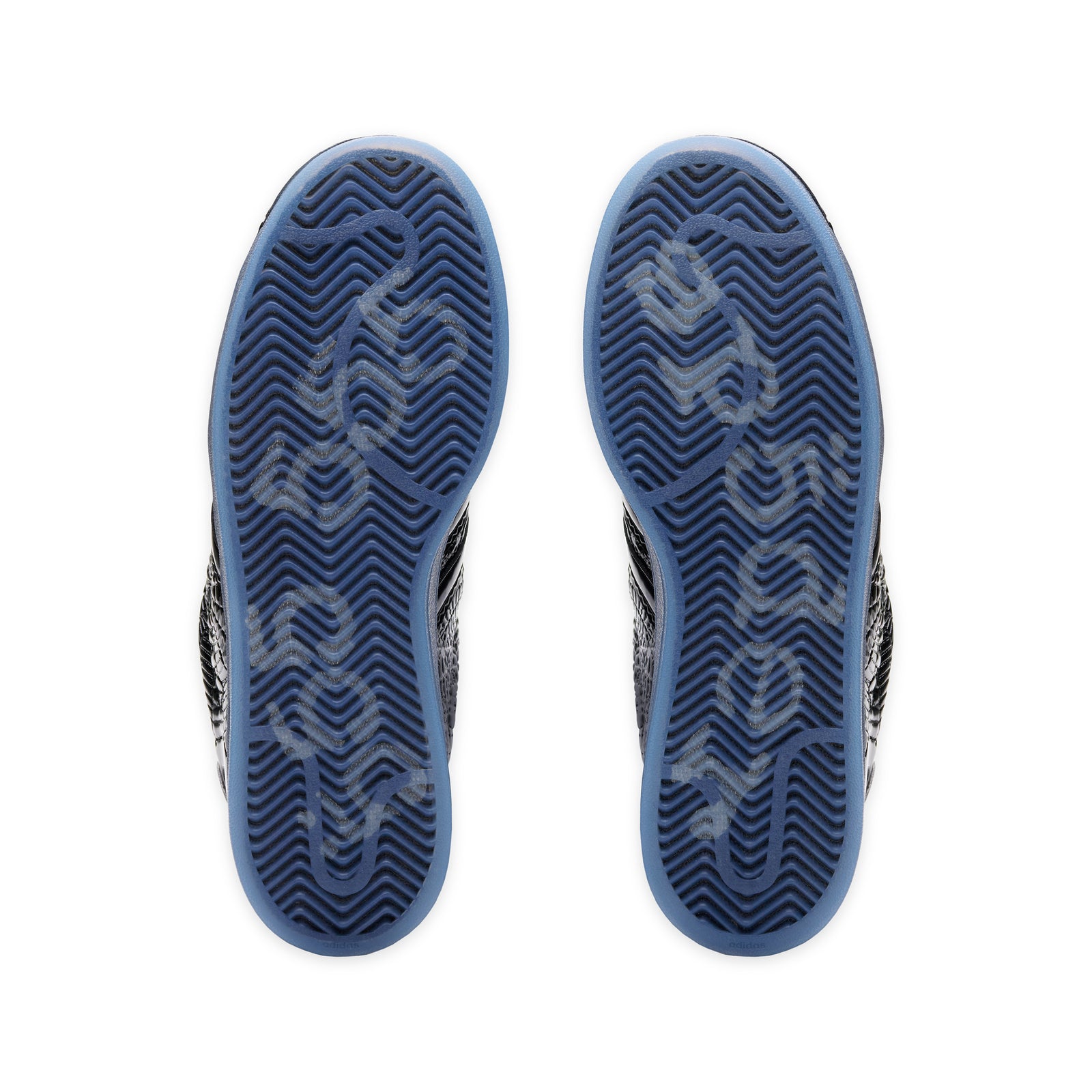 SP5DER x ADIDAS SUPERSTAR sneakers with translucent blue outsoles and tonal graphic detailing.
