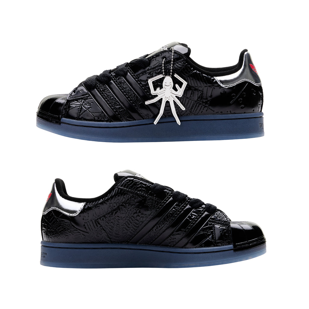 SP5DER x ADIDAS SUPERSTAR black glossy patent leather sneakers with spider charm and blue translucent sole.