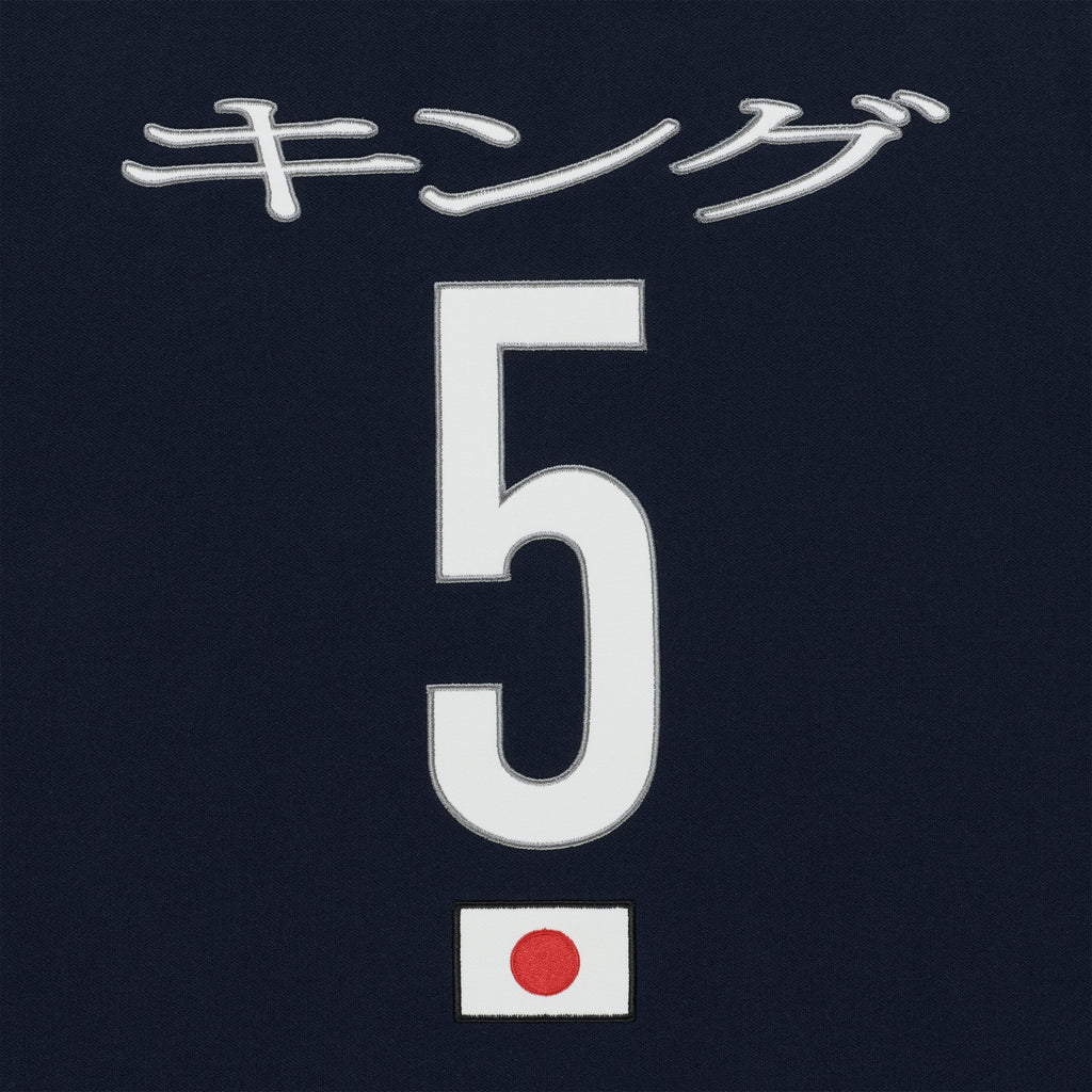 Navy polo with embroidered white Japanese text, large white number 5, and a small Japanese flag patch.