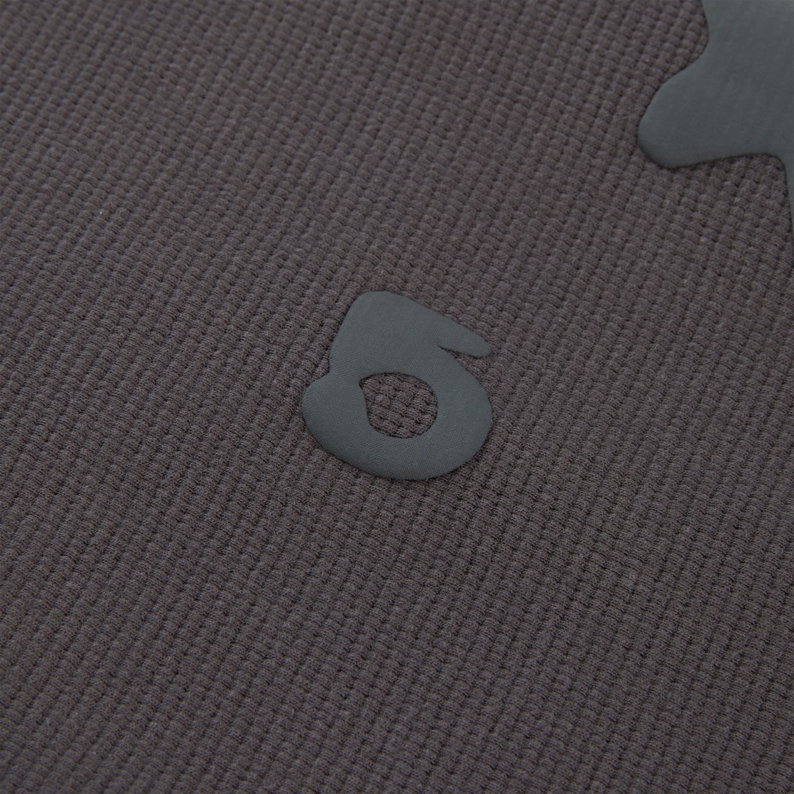 Close-up of a dark grey waffle knit BELUGA THERMAL with a raised, matte grey "5" print.