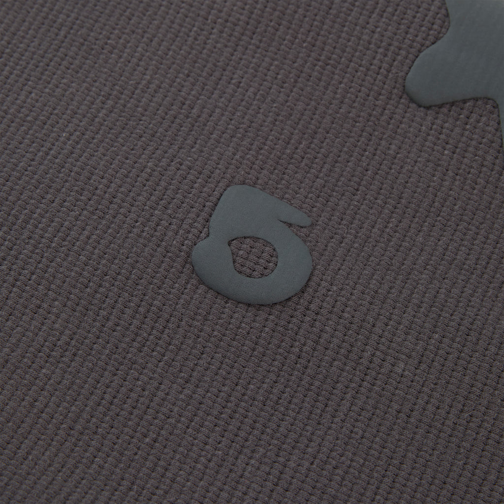 Close-up of a dark grey waffle knit BELUGA THERMAL with a raised, matte grey "5" print.
