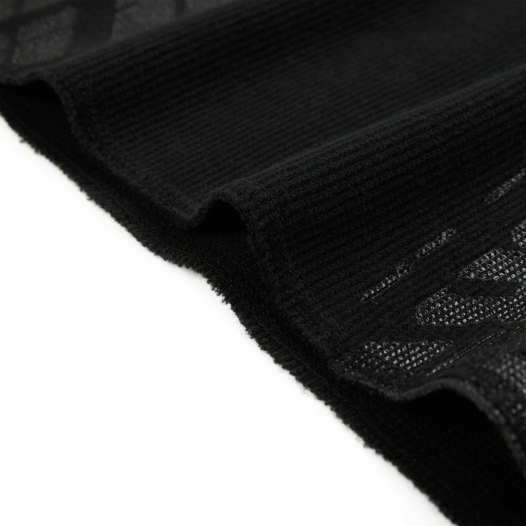Black waffle knit thermal with ribbed details and subtle tire track print.