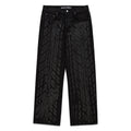 Black denim pants with all-over dark gray tire track design, five-pocket styling, and straight leg fit.