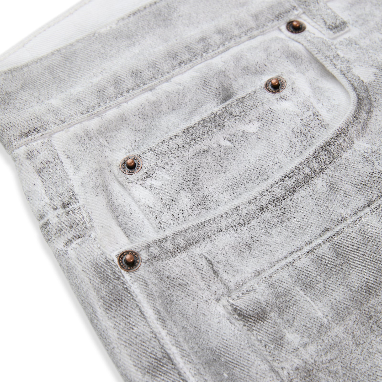 Platinum denim pant with spray-effect wash, custom hardware, and five-pocket styling.