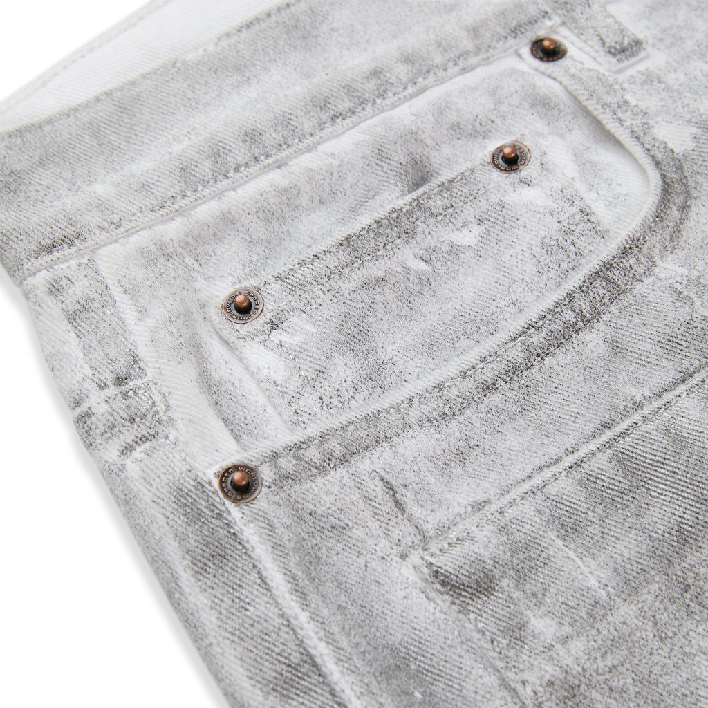 Platinum denim pant with spray-effect wash, custom hardware, and five-pocket styling.