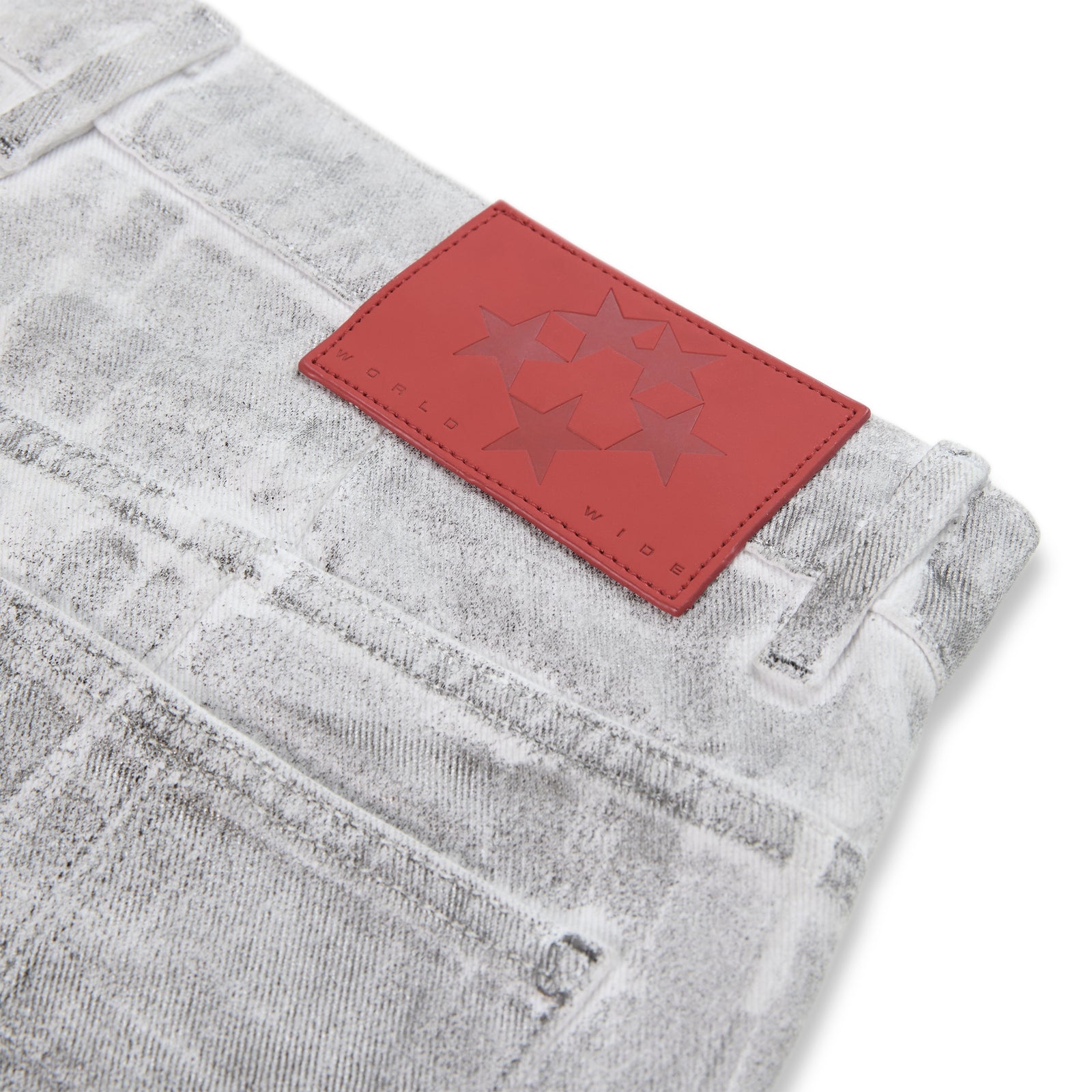 Platinum wide-leg denim pant with spray effect, red branded leather back patch, and belt loops.