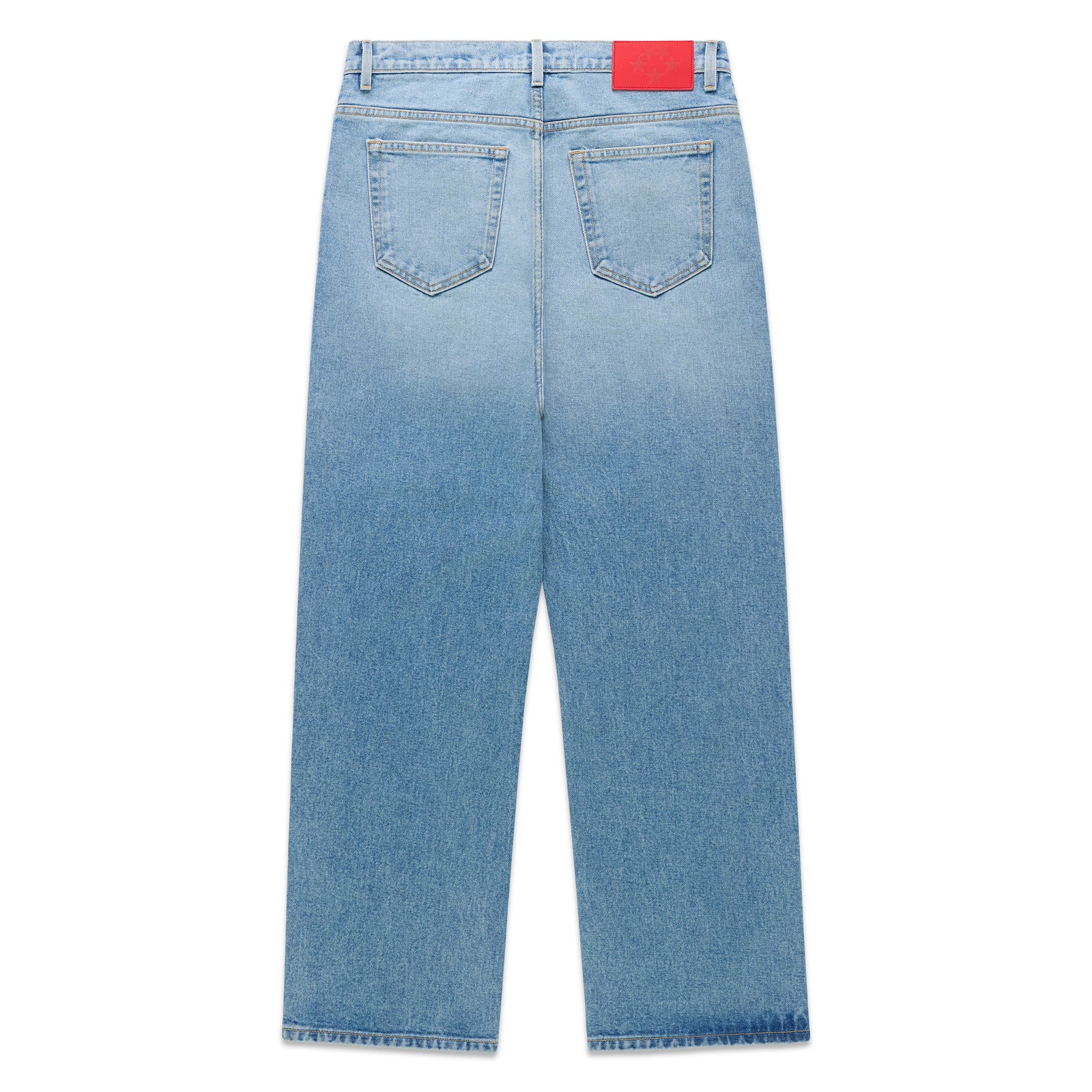 Vintage wash blue denim jeans with a red branded leather back patch and classic straight leg fit.