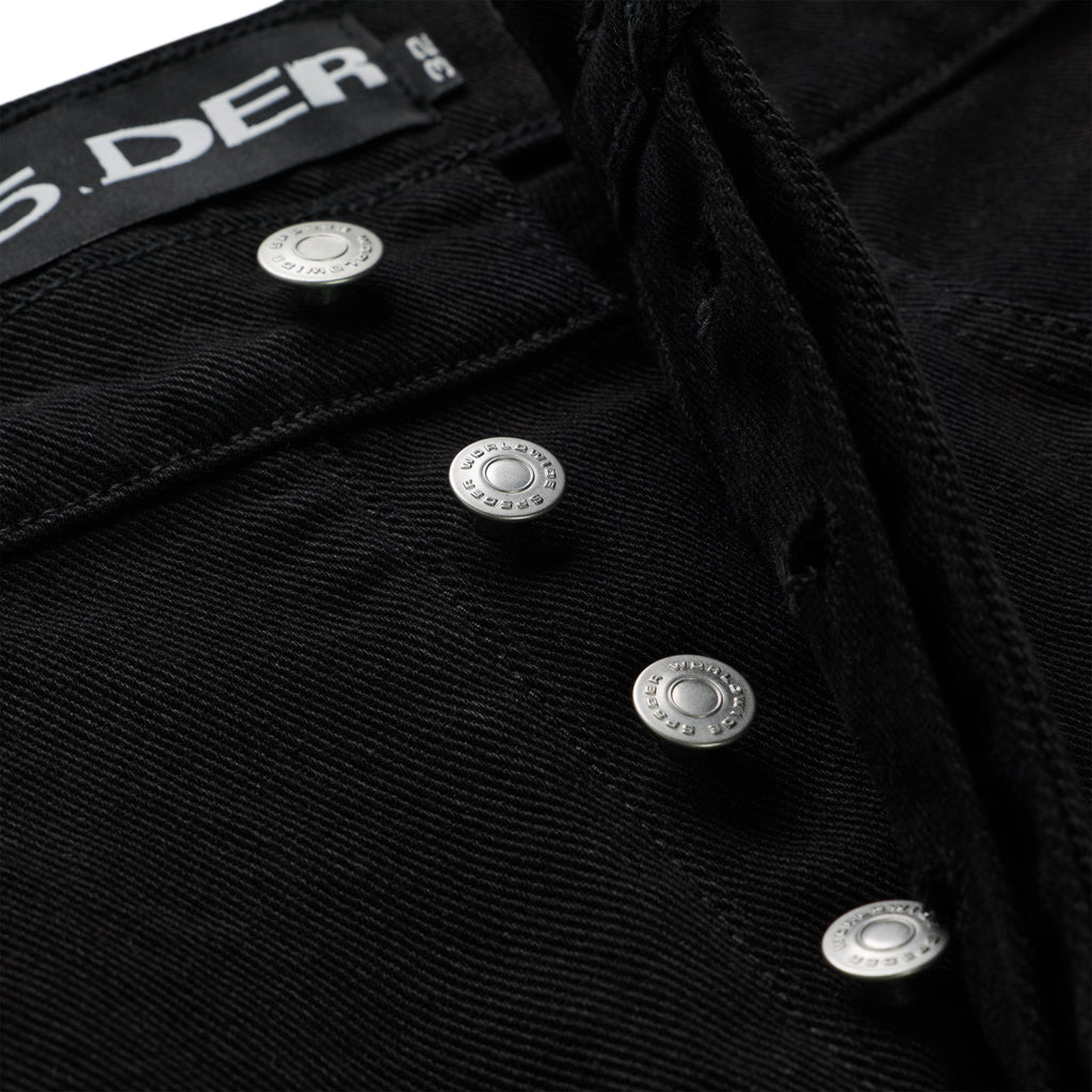 Close-up of OXY JEAN's black 13oz denim fly with branded silver shank buttons and black waistband.