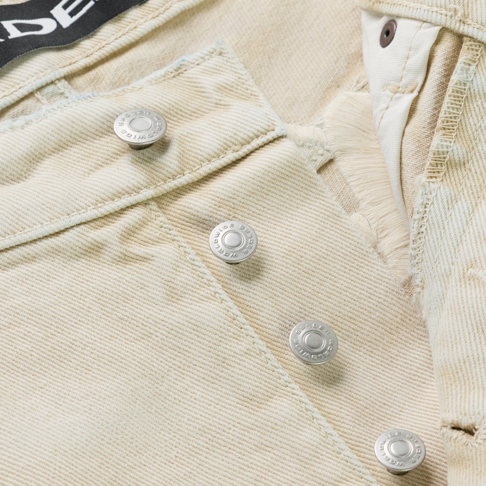 Close-up of OXY JEAN's light beige 13oz denim, showing branded shank buttons and fly.