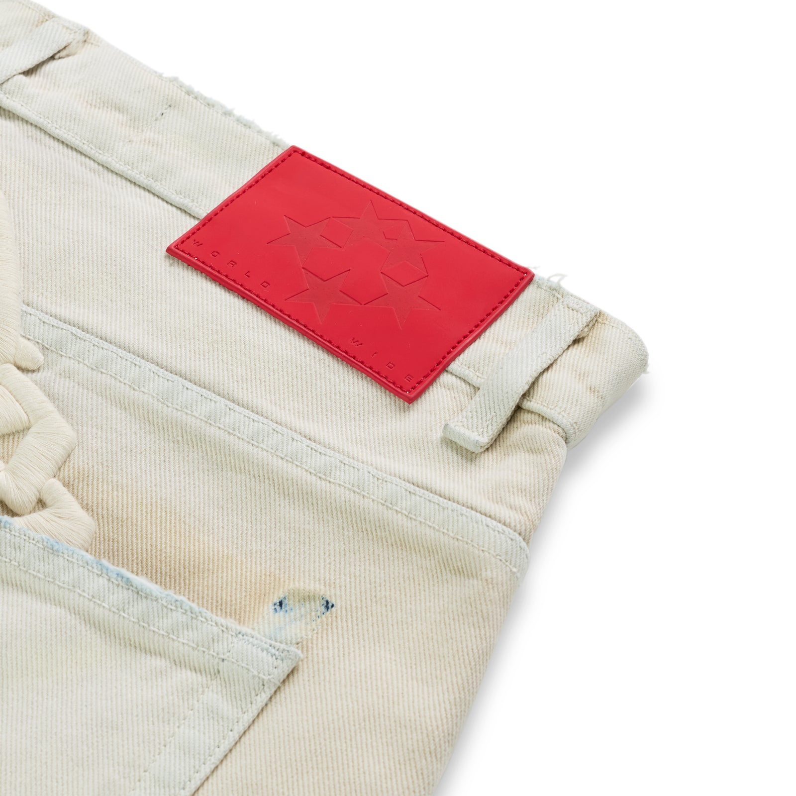 OXY JEAN light wash denim with red leather back patch, embroidered text, and custom hardware.