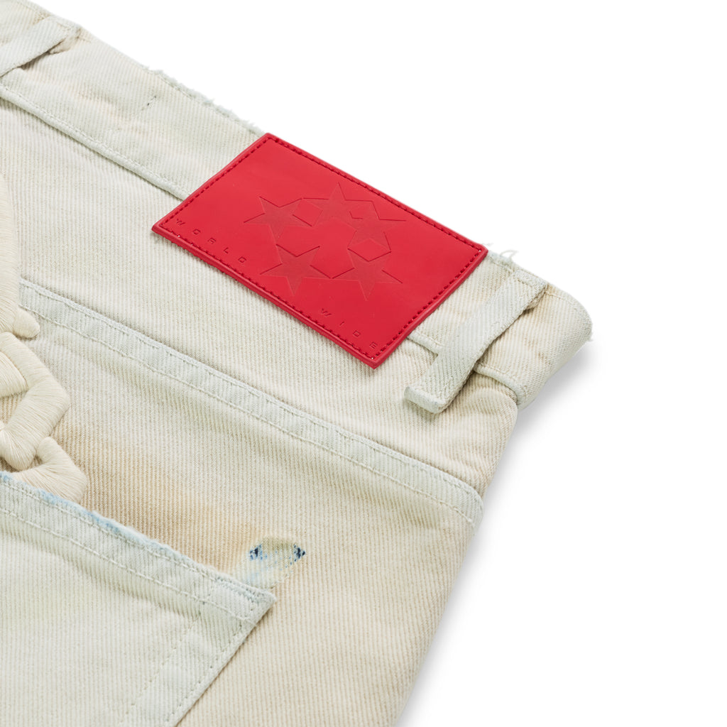 OXY JEAN light wash denim with red leather back patch, embroidered text, and custom hardware.