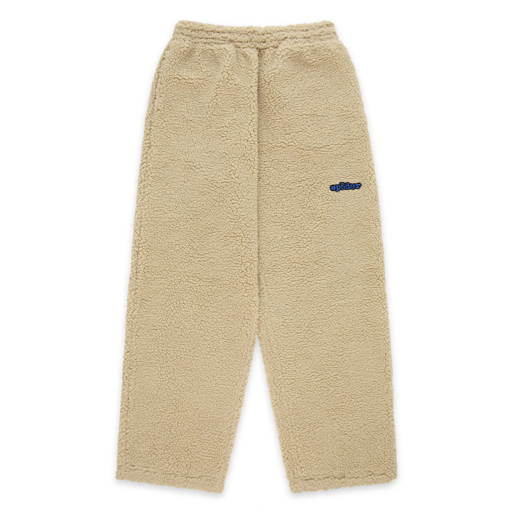 Beige teddy fleece pant with elasticized drawstring waistband and blue rubberized logo patch.