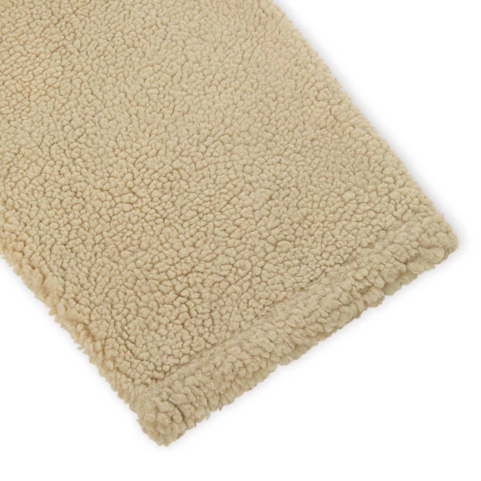 Close-up of a beige teddy sherpa fleece pant leg, showing the soft, textured material.