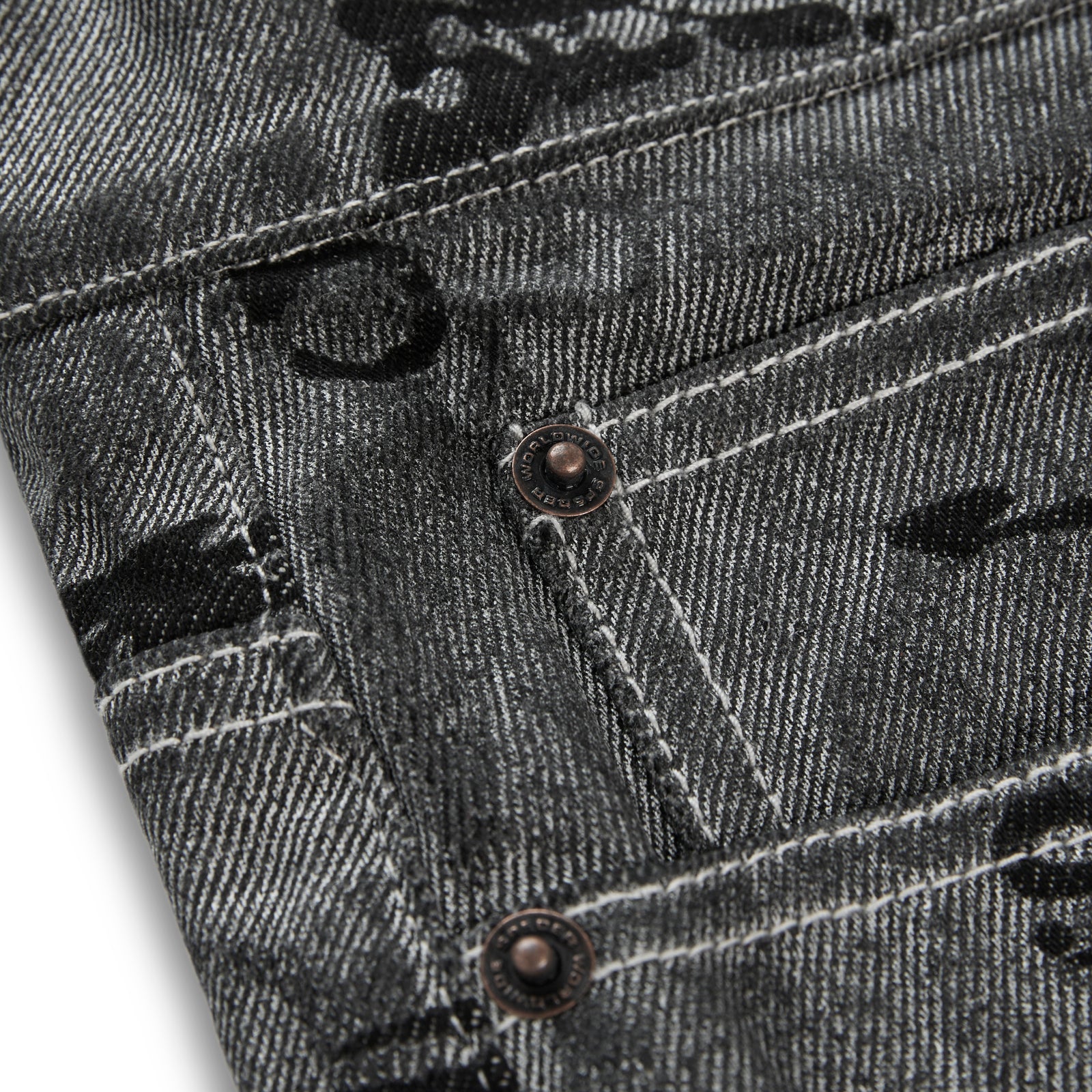 Washed black denim pants with all-over print, red contrast stitching, belt loops, and branded SP5DER hardware.