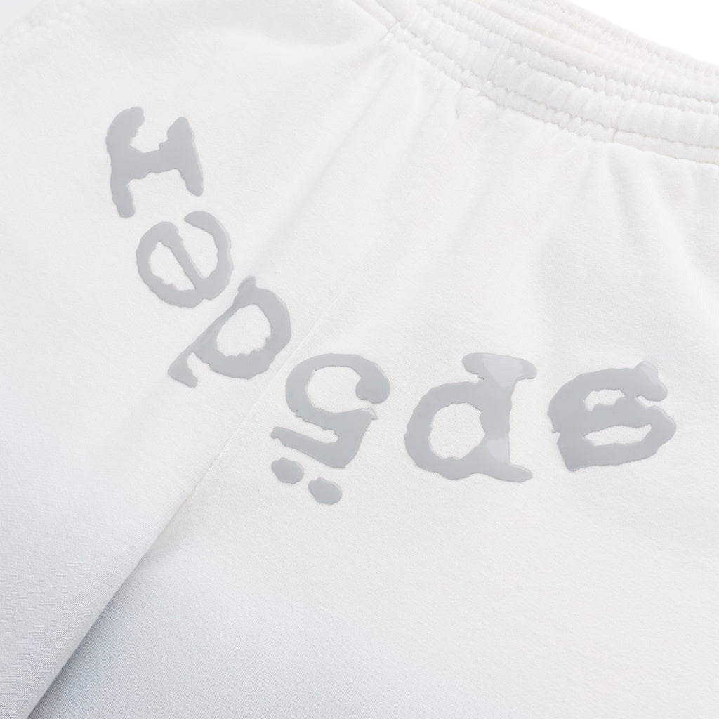 White cotton fleece sweatpants with "SP5DER" puff print at the crotch and an ombre design.