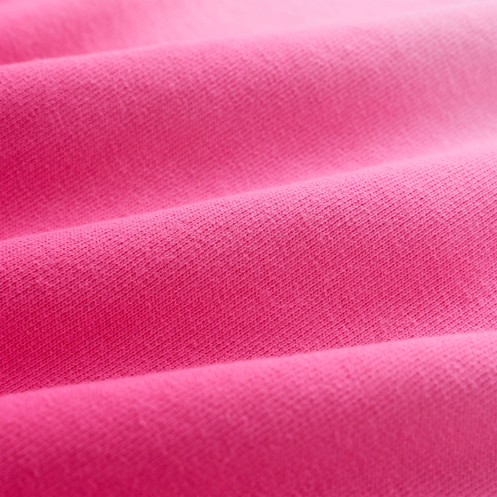 Close-up of OG WEB OMBRE SWEATPANT, showing bright pink 100% cotton fleece fabric with subtle folds.