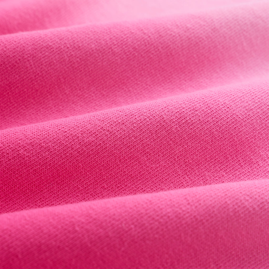 Close-up of OG WEB OMBRE SWEATPANT, showing bright pink 100% cotton fleece fabric with subtle folds.