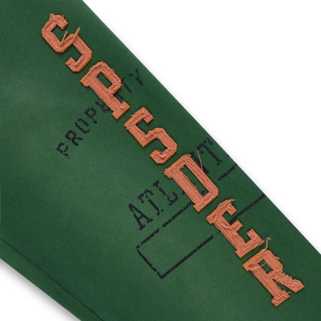 Green cotton fleece sweatpant with raised, frayed orange "SP5DER" lettering and faded graphic print.