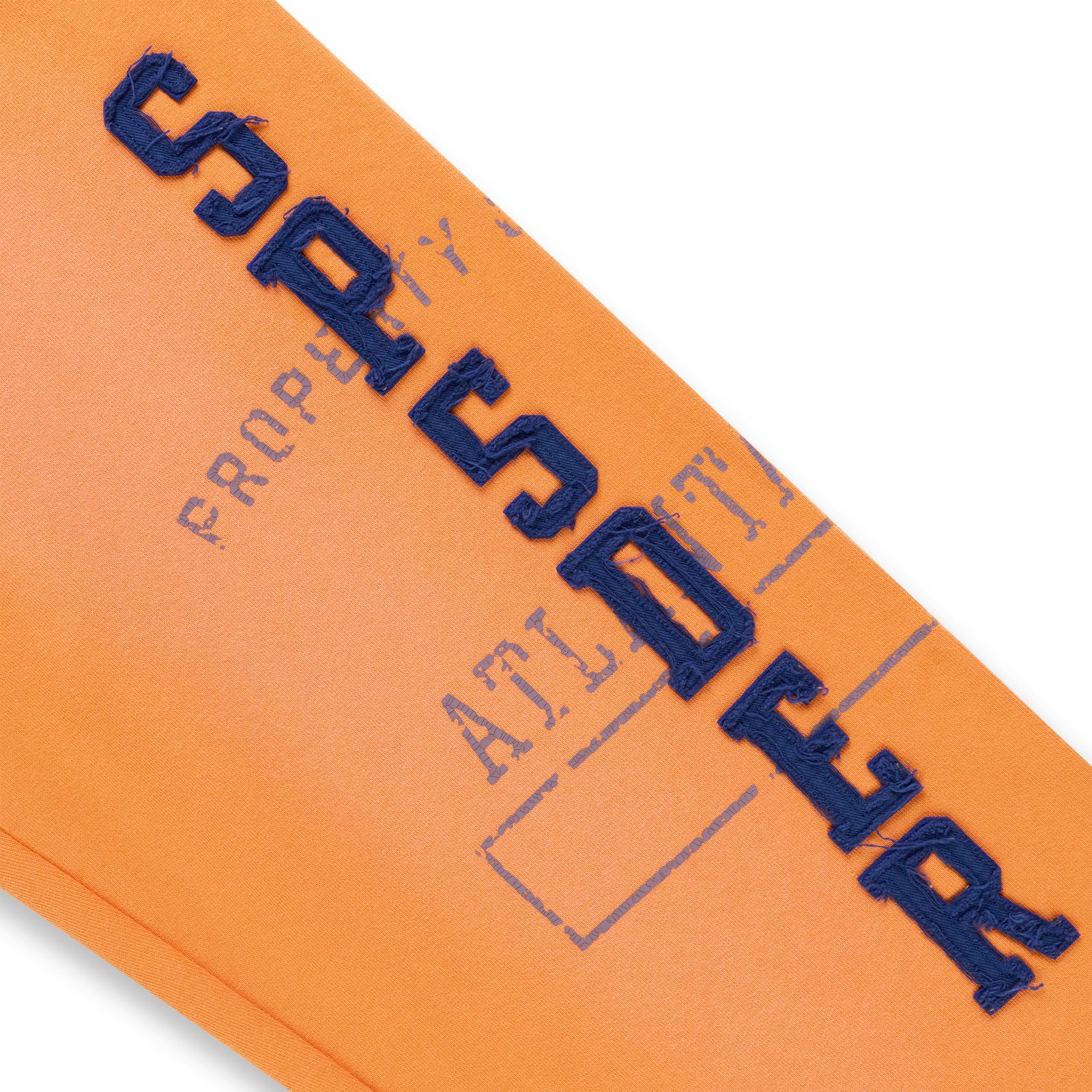 Orange cotton fleece sweatpant with raised, frayed blue "SPSDER" lettering and faded graphic print.
