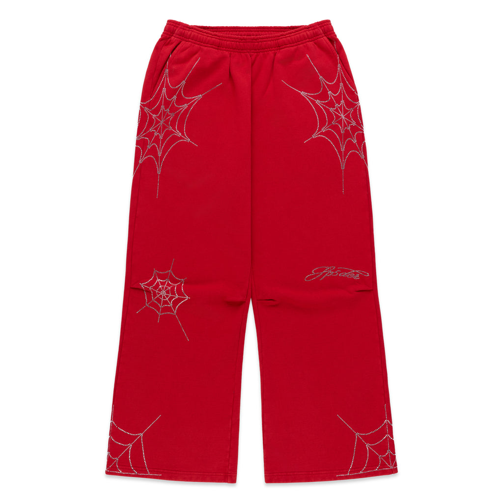 Red cotton fleece sweatpants with rhinestone spider web and text details, wide-leg silhouette.