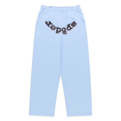 Light blue cotton fleece sweatpants with a wide-leg silhouette and a studded OG logo appliqué across the crotch.