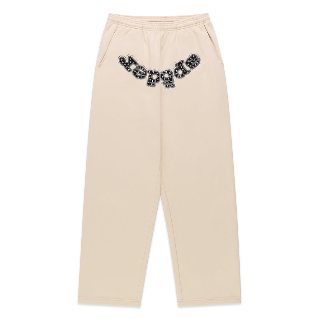 Beige cotton fleece sweatpants with "OG LOGO" appliqué across the crotch, embellished with mixed metal studs.