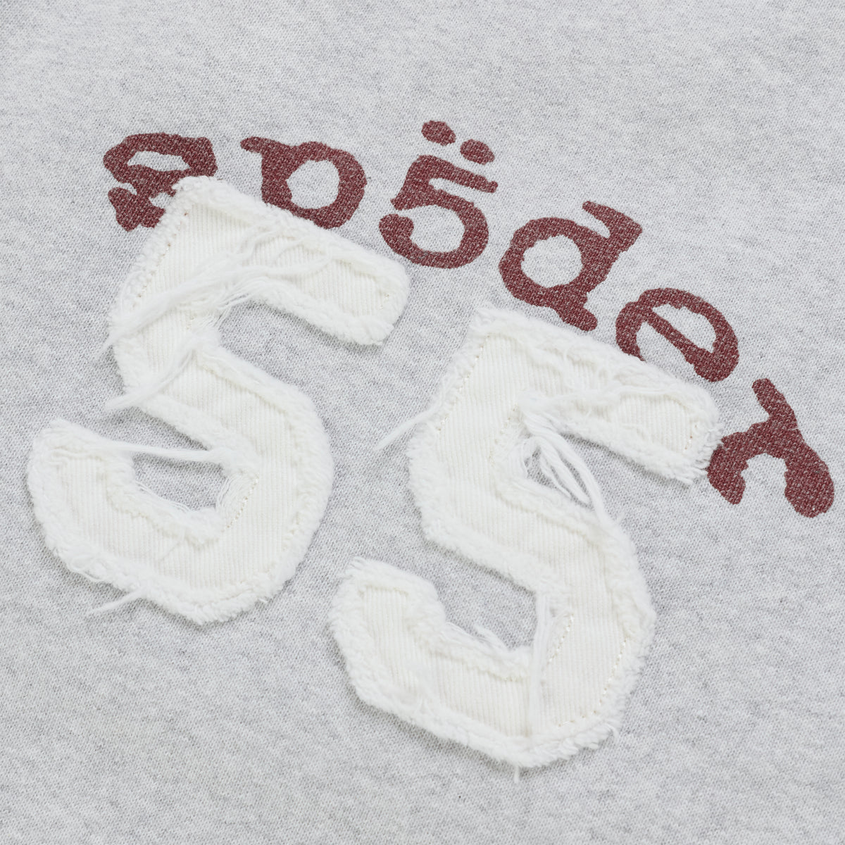 Grey cotton fleece sweatpants with a white distressed 55 applique and arched brown graphic print logo.
