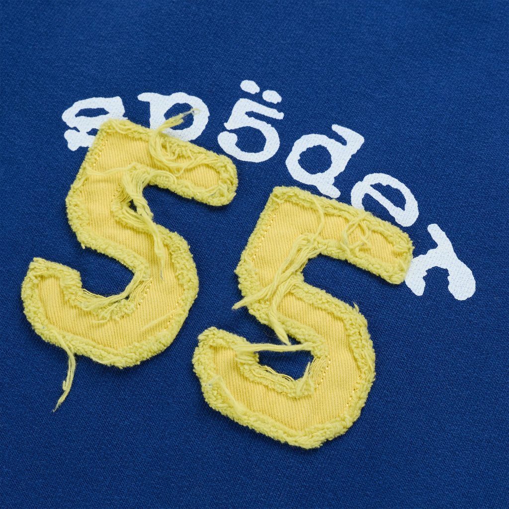 Blue cotton fleece with a distressed yellow 55 applique and white arched graphic print.