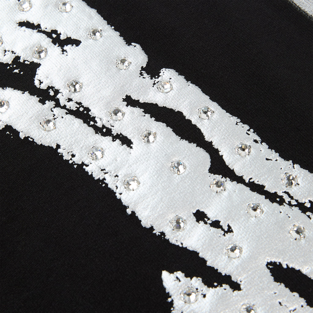 Black cotton fleece sweatpant with white sprayed-effect stripe and rhinestone "SP5DER" logo detail.