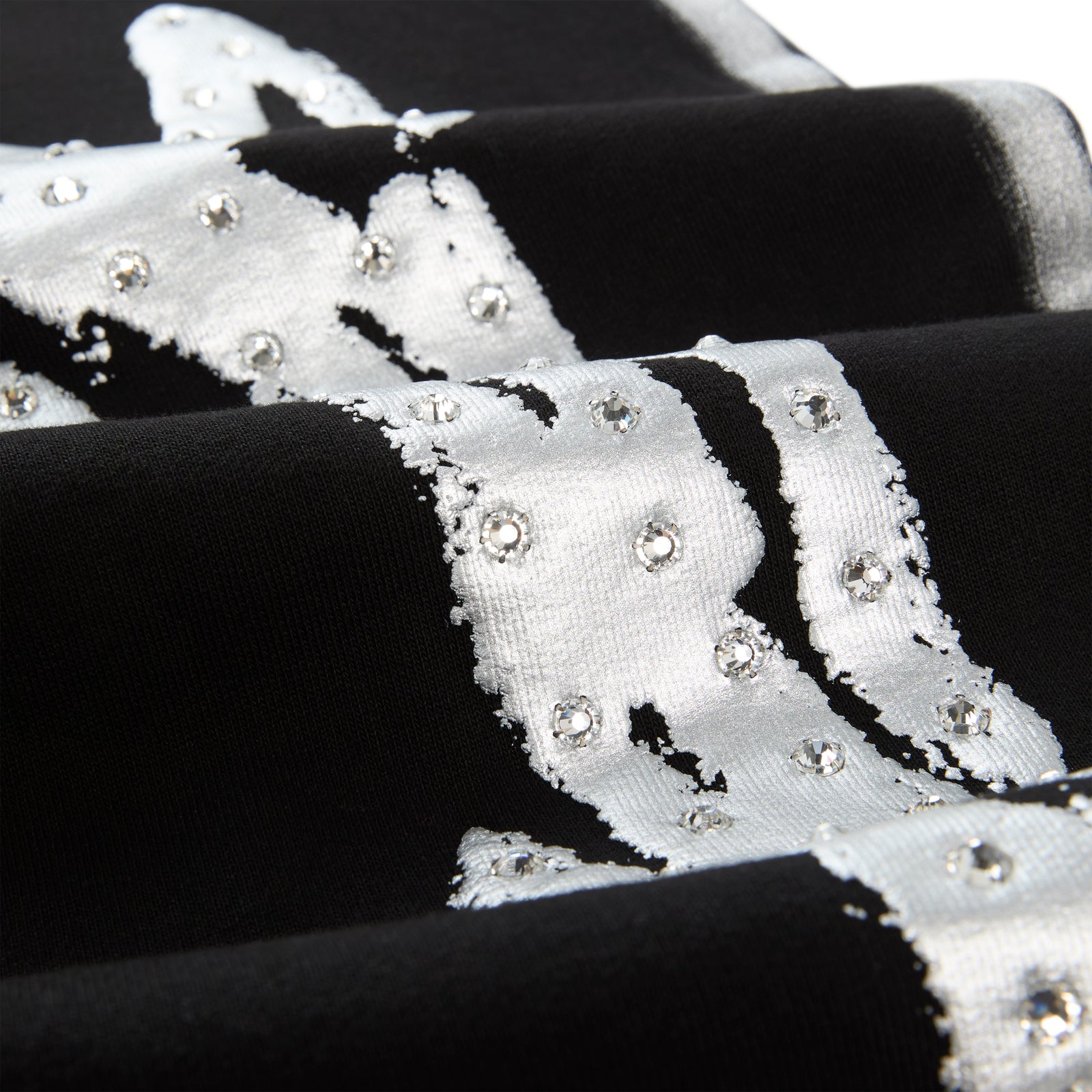 Black cotton fleece sweatpant with "SP5DER" logo, rhinestone accents, and sprayed-effect stripe.