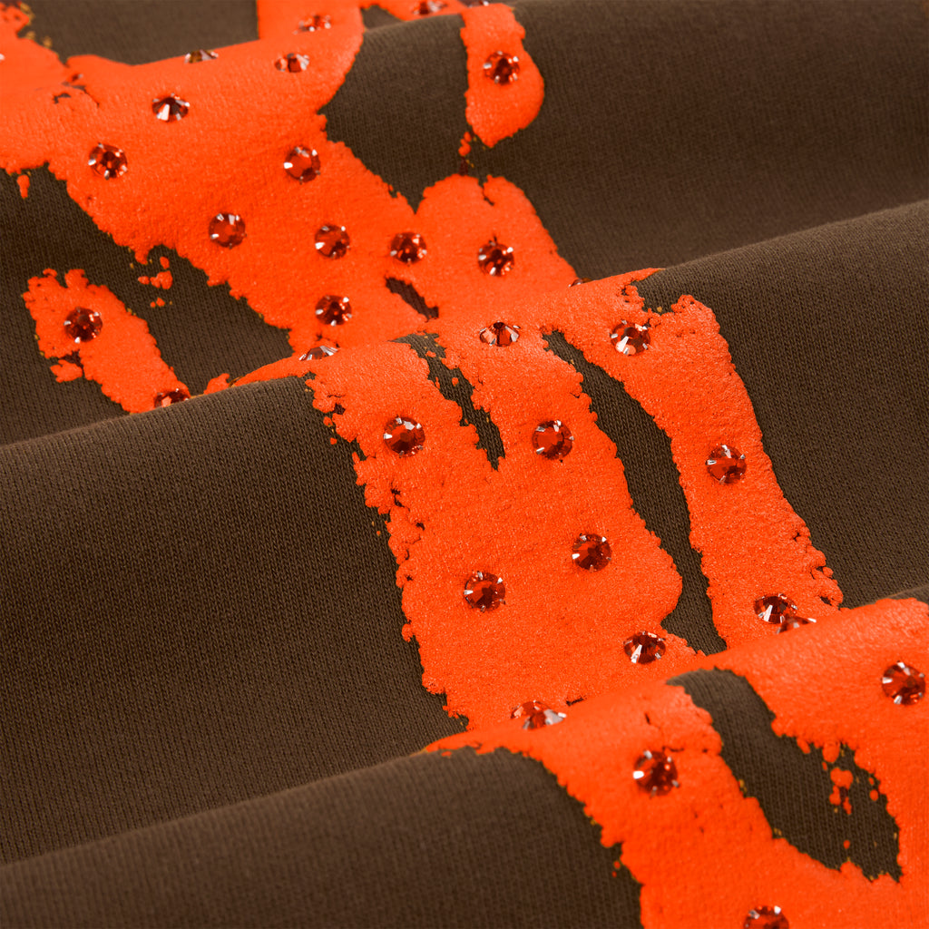 Brown cotton fleece sweatpant with orange "SP5DER" logo and rhinestone accents.